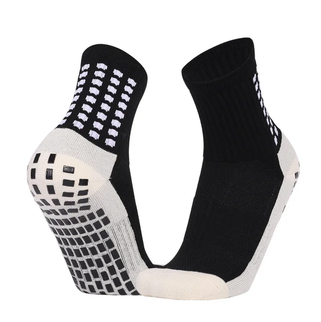 Black and cream crew football grip socks shown from the side and sole, with rectangular raised grip pads