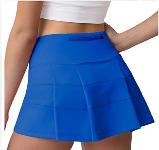 Back view of a blue sports skort showing the rear waist zipper pocket and pleated skirt shell