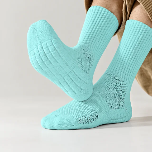 Unbranded customization mockup of mint-blue crew sports socks with ribbed cuffs and cushioned knit soles