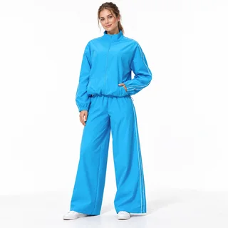 AI-assisted visualization of a women's bright blue zip jacket and wide-leg tracksuit set